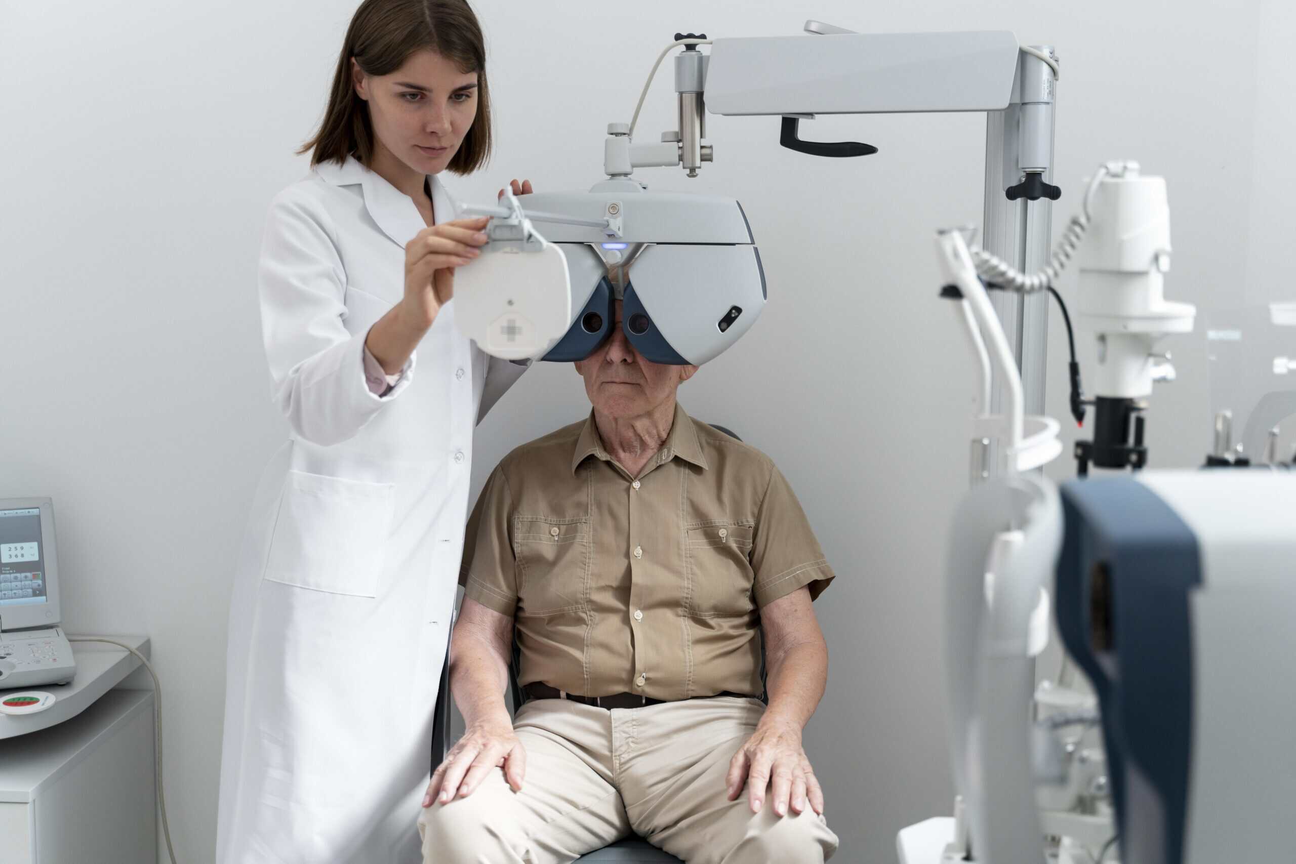 Optometrist performing eye exam on elderly patient with advanced equipment.